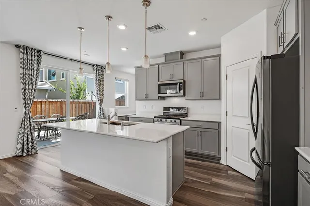 a kitchen with kitchen island white cabinets and stainless steel appliances