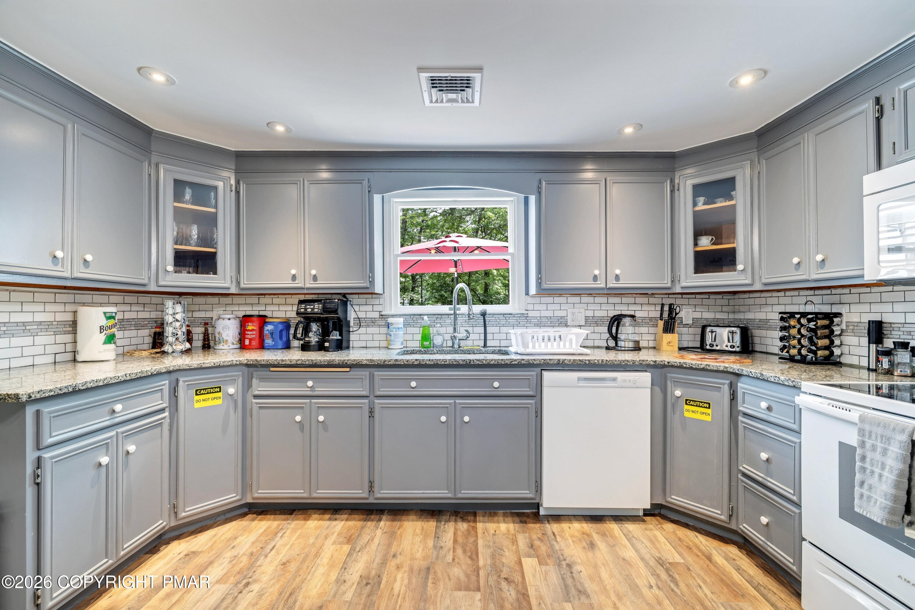 1106 Lakeside Drive Effort, PA 18330 - Photo 24 of 42 a kitchen with stainless steel appliances granite countertop a stove top oven a sink dishwasher and cabinets with wooden floor