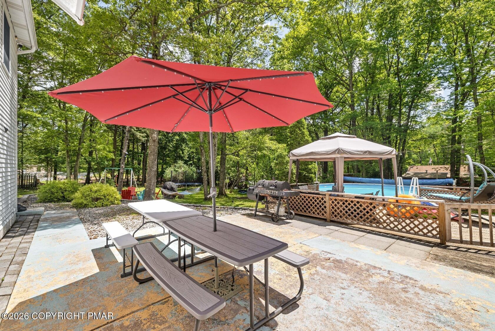 1106 Lakeside Drive Effort, PA 18330 - Photo 9 of 42 a view of a patio with a table and chairs under an umbrella