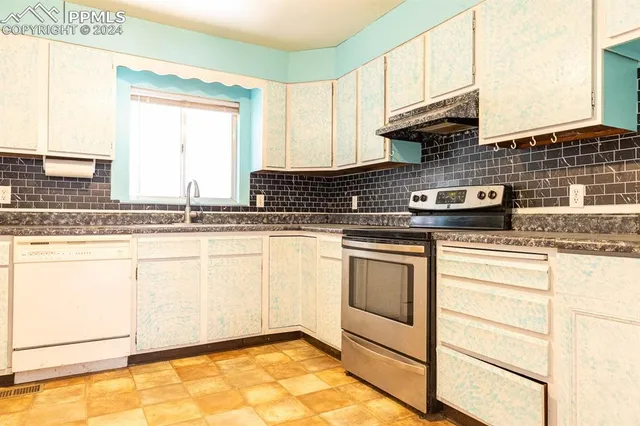 a kitchen with kitchen island granite countertop white cabinets and white appliances
