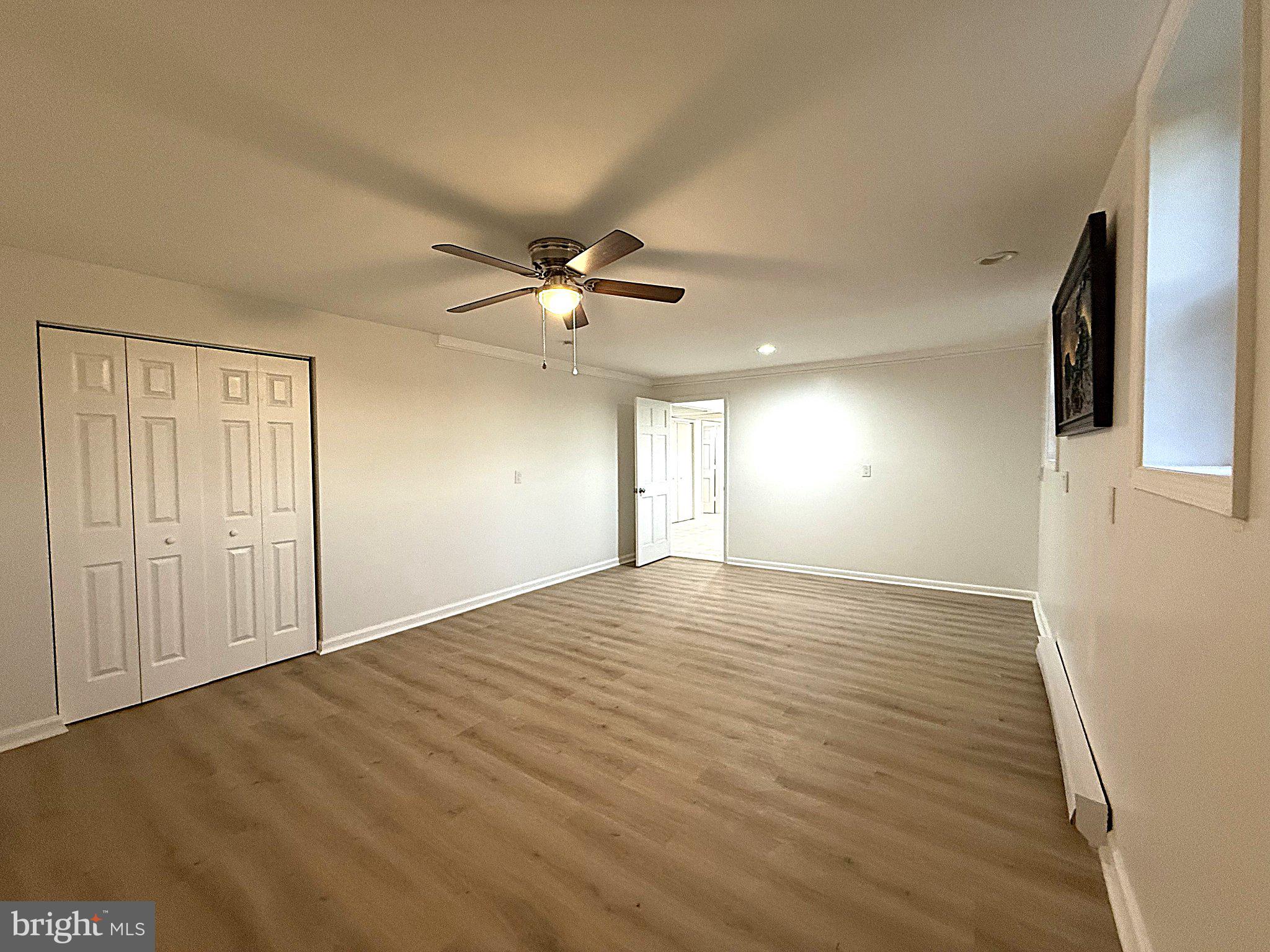 404 Woodbrook Road Lancaster, VA 22503 - Photo 54 of 60 an empty room with wooden floor fan and windows