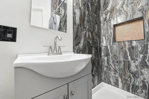 a bathroom with a toilet sink and mirror