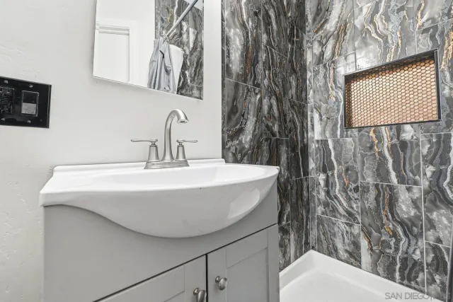 a bathroom with a toilet sink and mirror
