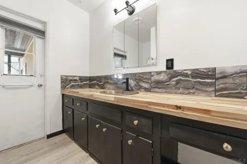 a bathroom with a sink and a mirror