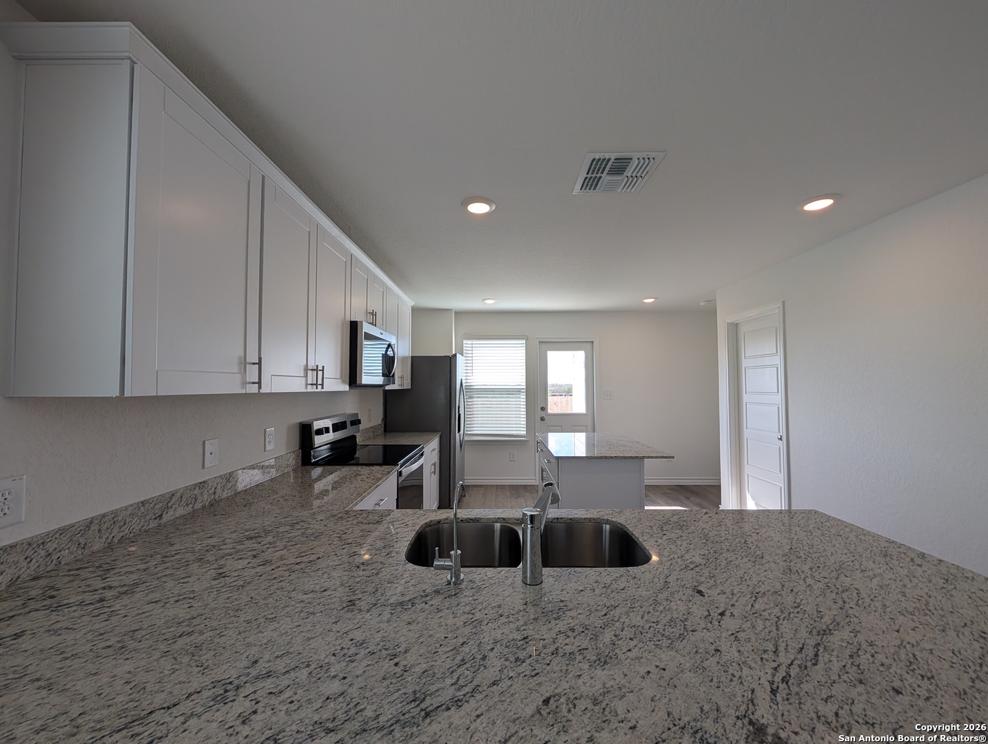 862 Bluegrass New Braunfels, TX 78130 - Photo 12 of 37 a large white kitchen with a large window
