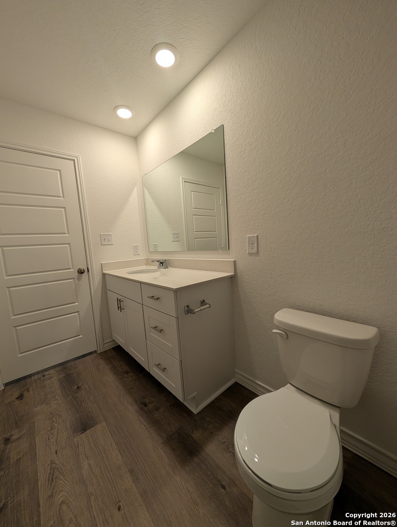 862 Bluegrass New Braunfels, TX 78130 - Photo 23 of 37 a bathroom with a toilet a sink and mirror