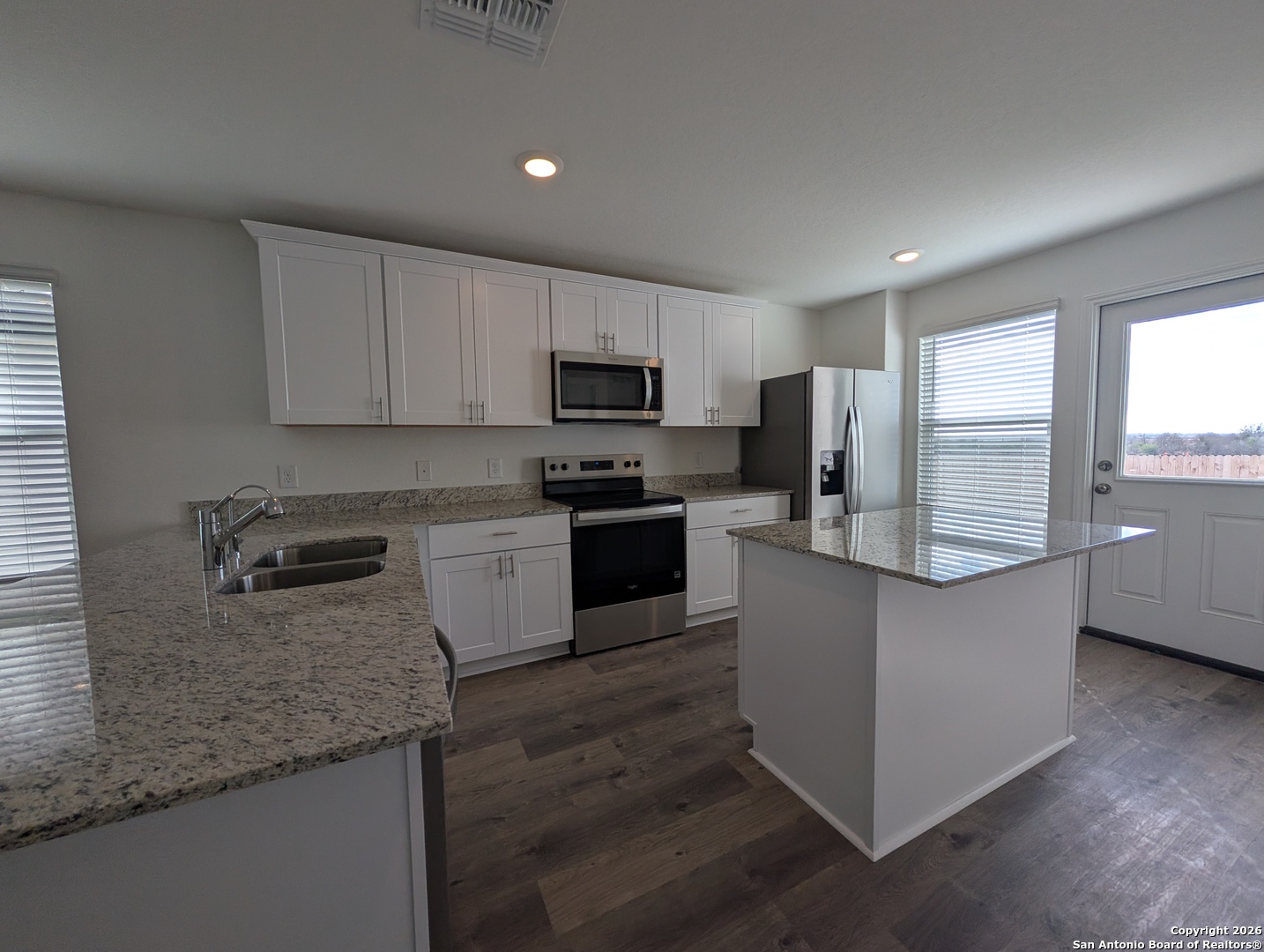 862 Bluegrass New Braunfels, TX 78130 - Photo 8 of 37 a kitchen with stainless steel appliances granite countertop a stove a sink and a refrigerator