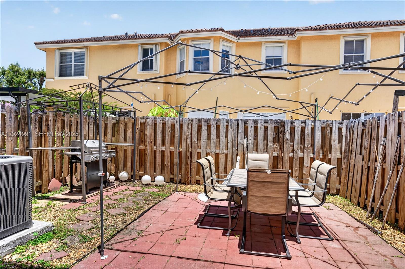 16651 Southwest 79th Terrace Miami, FL 33193 - Photo 25 of 34 a view of a patio with a table and chairs