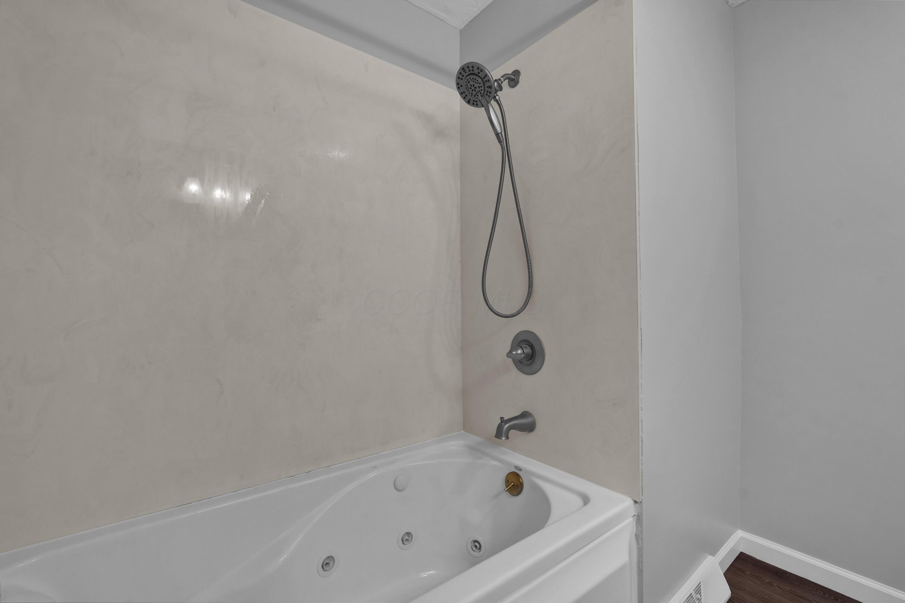 208 Cumberland Road Delaware, OH 43015 - Photo 20 of 37 Updated bathroom with jetted tub, easy-to-clean tub surround, LVP flooring, and updated vanity!