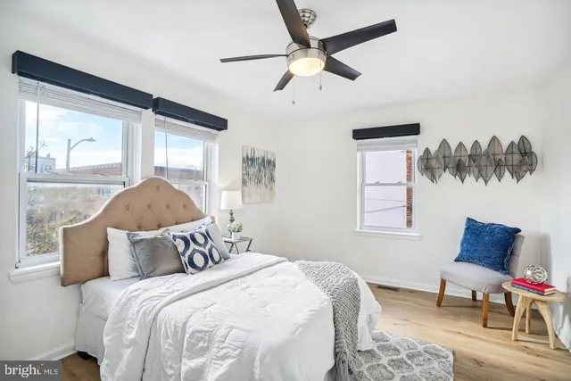 a bedroom with a bed and a painting on the wall