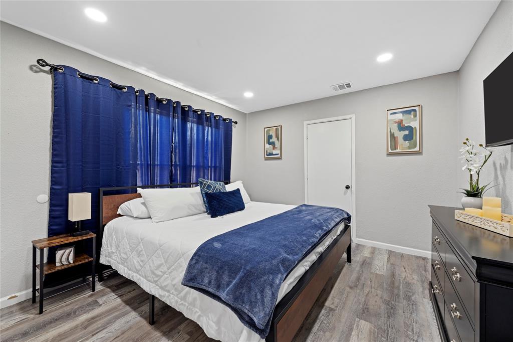 1900 North 6th Street Waco, TX 76708 - Photo 18 of 23 a bedroom with a bed and a flat screen tv