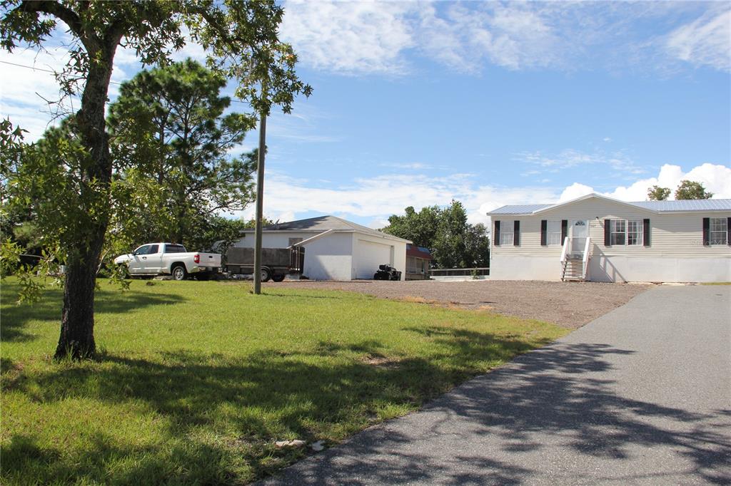 13127 Star Road Brooksville, FL 34613 - Photo 39 of 54 a front view of a house with a yard and garage