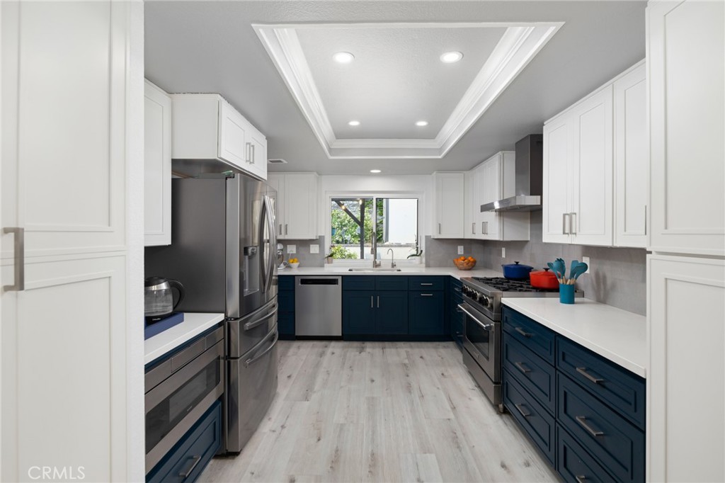 873 Calle Del Sol Upland, CA 91784 - Photo 15 of 41 a kitchen with stainless steel appliances granite countertop a refrigerator a stove top oven and a sink