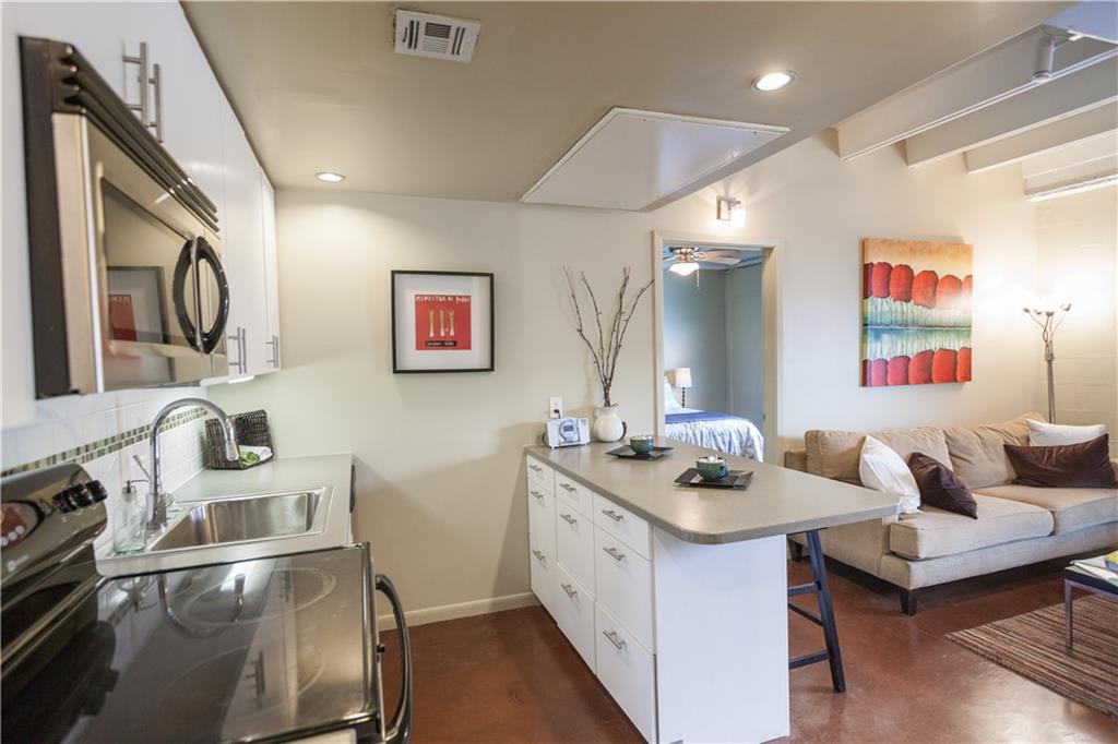 2408 Leon Street, Unit 109 Austin, TX 78705 - Photo 5 of 10 a kitchen with a sink stove and microwave