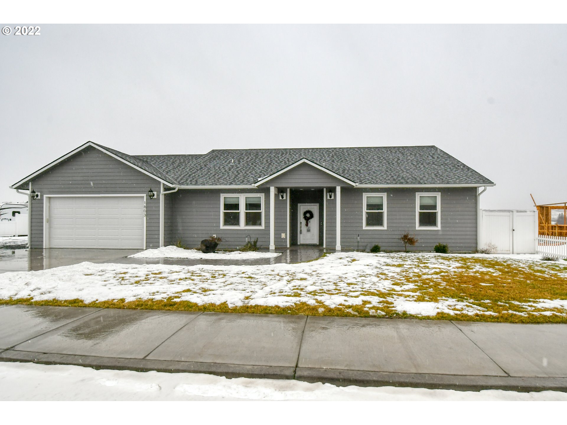 a view of house with yard and garage