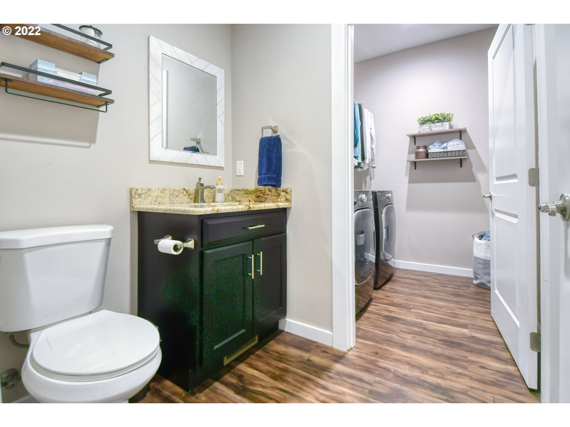 1803 Southwest 3rd Street Pendleton, OR 97801 - Photo 14 of 32 a bathroom with a granite countertop toilet sink and mirror