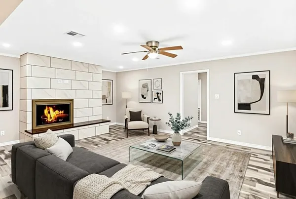 a living room with furniture a flat screen tv and a fireplace
