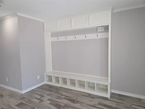 a view of an empty room with wooden floor