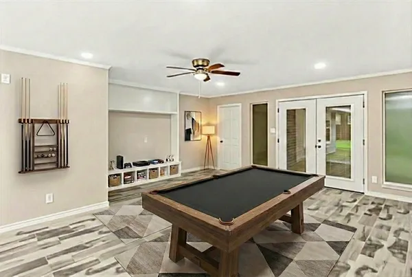 a room with pool table and windows