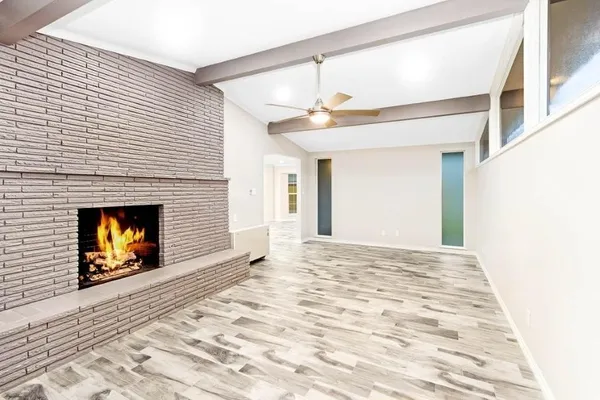 a view of an empty room and fire place