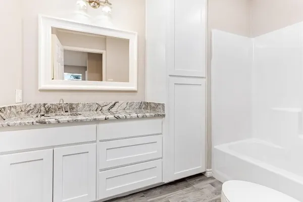 a bathroom with a bathtub and a sink