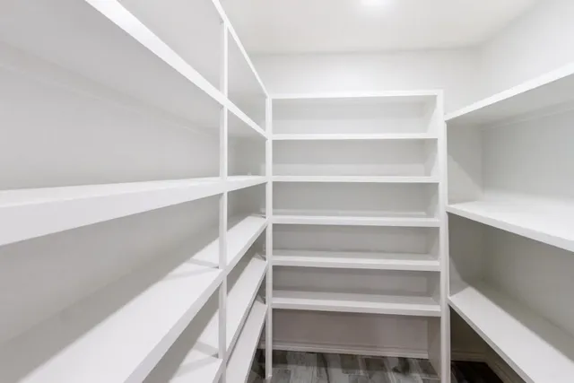 a view of walk in closet with empty racks