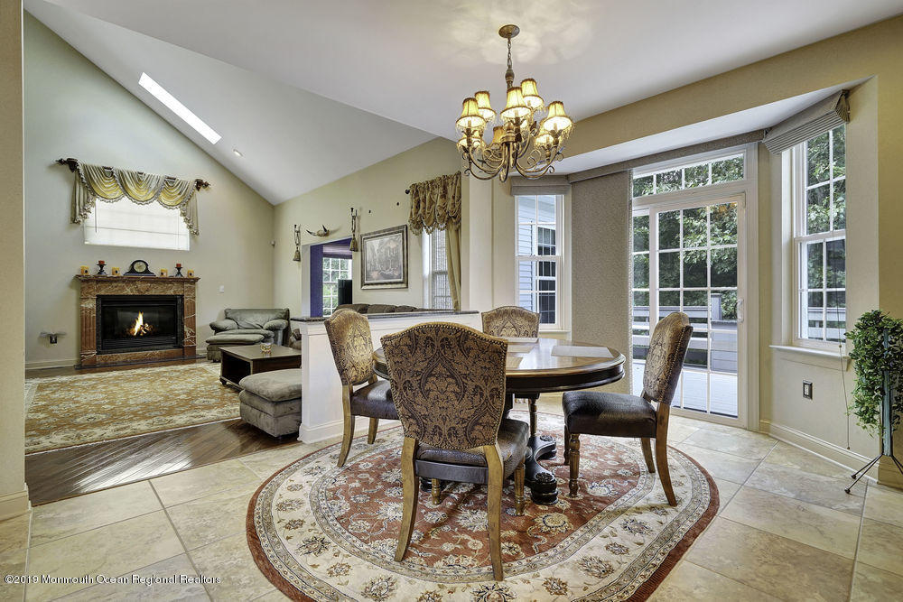 2 Emily Road Manalapan, NJ 07726 - Photo 22 of 61 a view of a dining room with furniture a chandelier and wooden floor