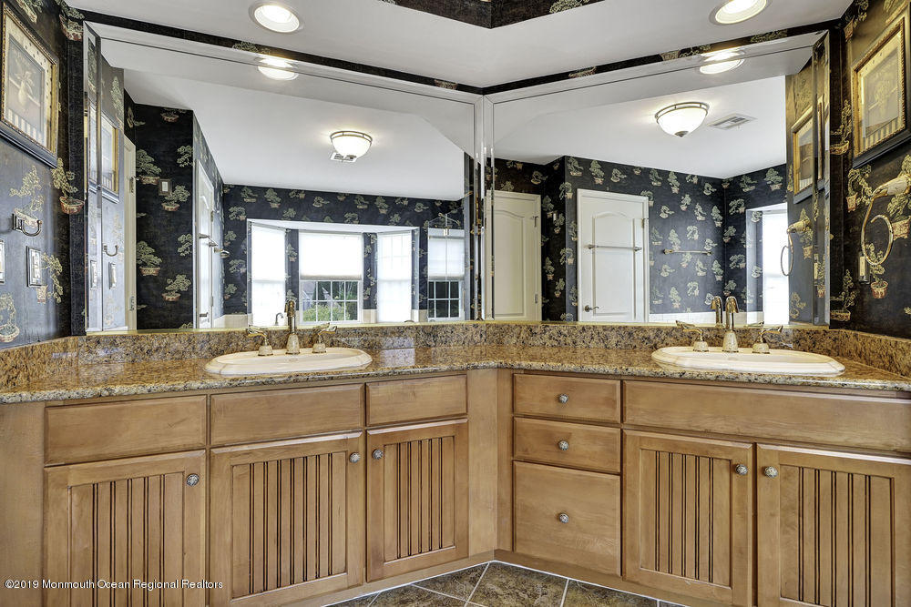 2 Emily Road Manalapan, NJ 07726 - Photo 50 of 61 a bathroom with a granite countertop sink a large mirror and a bathtub next to a window
