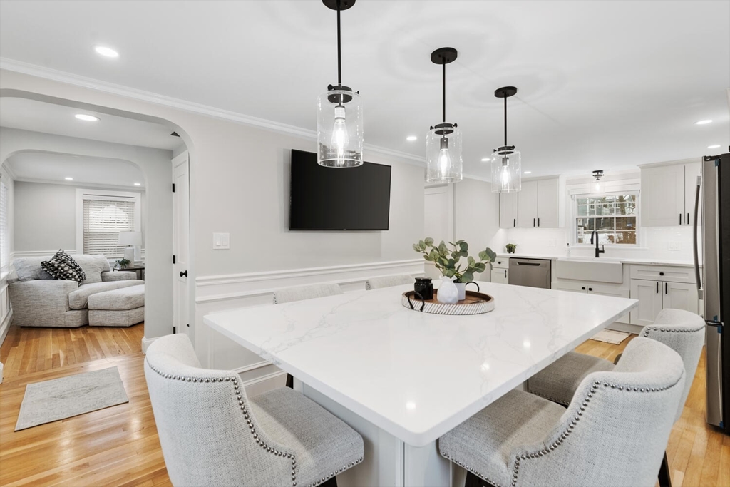 53 Perkins Street Stoneham, MA 02180 - Photo 14 of 34 a dining room with furniture and a flat screen tv