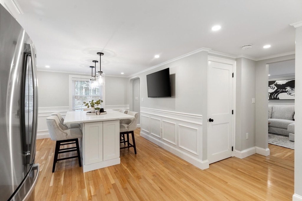 53 Perkins Street Stoneham, MA 02180 - Photo 19 of 34 a kitchen with a sink stainless steel appliances and white cabinets