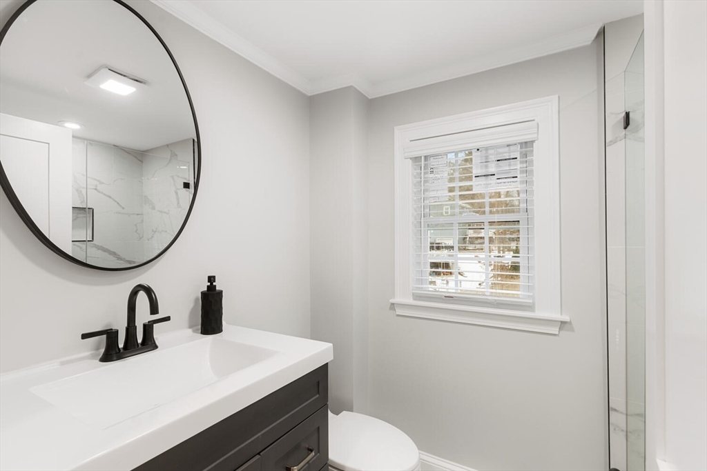 53 Perkins Street Stoneham, MA 02180 - Photo 26 of 34 a bathroom with a sink a toilet and a mirror