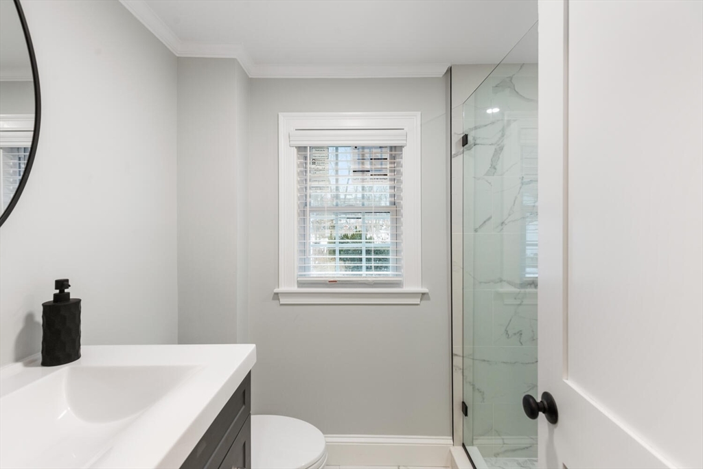 53 Perkins Street Stoneham, MA 02180 - Photo 27 of 34 a bathroom with a sink a toilet and shower