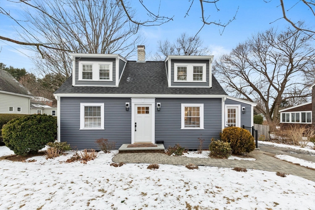 53 Perkins Street Stoneham, MA 02180 - Photo 3 of 34 a front view of a house with a yard covered in snow