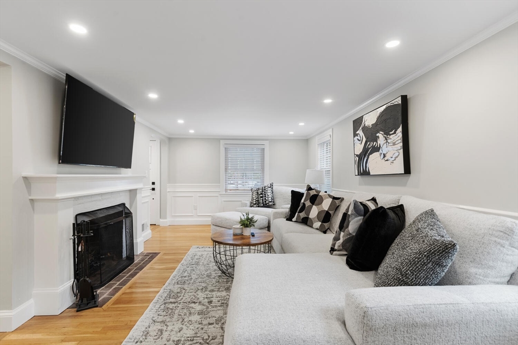 53 Perkins Street Stoneham, MA 02180 - Photo 6 of 34 a living room with furniture a fireplace and a flat screen tv