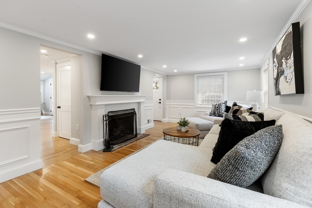 53 Perkins Street Stoneham, MA 02180 - Photo 7 of 34 a living room with furniture a fireplace and a flat screen tv