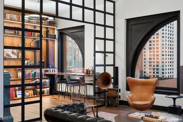 a living room with furniture fireplace and a window