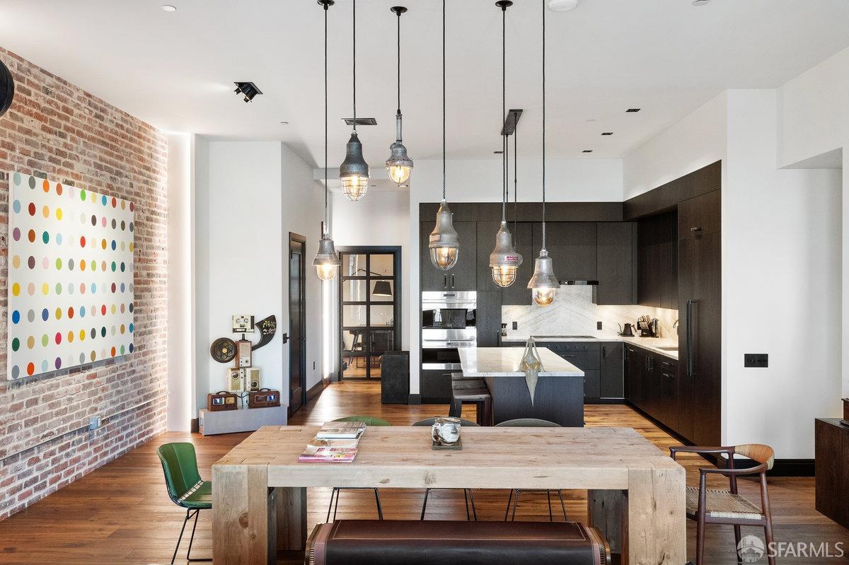 706 Mission Street, Unit 1001 San Francisco, CA 94103 - Photo 17 of 88 a view of kitchen and dining room with furniture wooden floor and chandelier