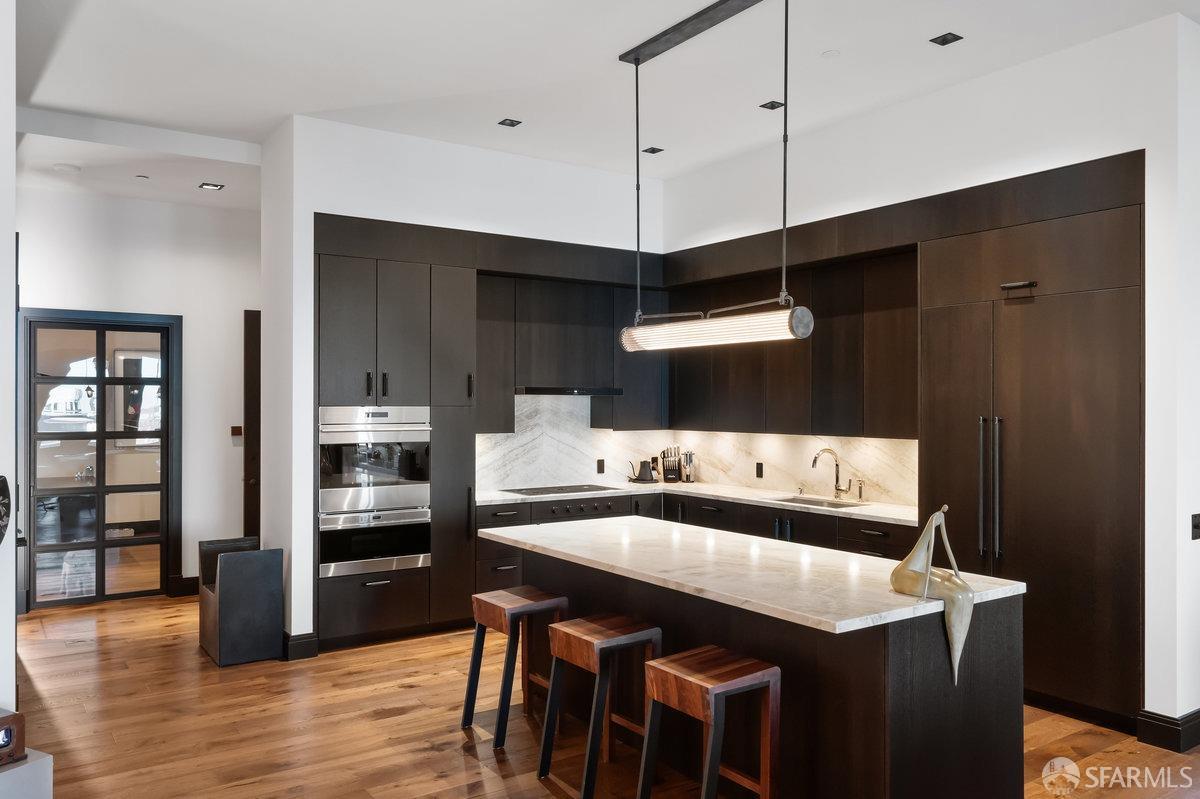 706 Mission Street, Unit 1001 San Francisco, CA 94103 - Photo 18 of 88 a kitchen with stainless steel appliances a sink and a refrigerator