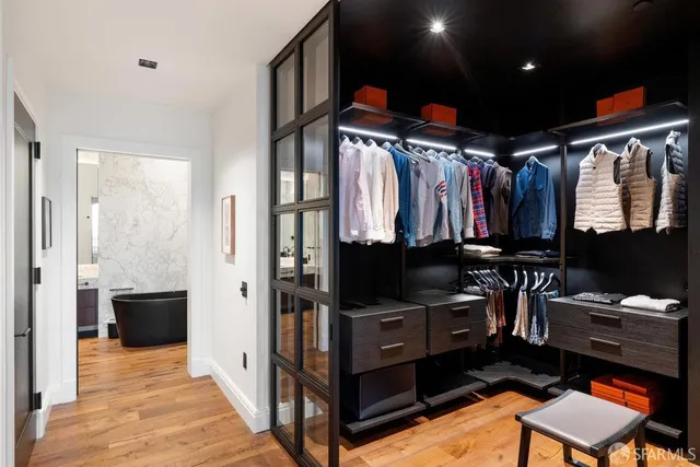 a bathroom with a glass door shower and a sink