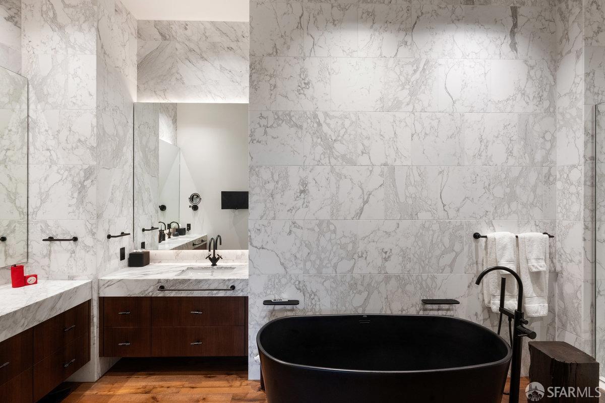 706 Mission Street, Unit 1001 San Francisco, CA 94103 - Photo 30 of 88 a bathroom with a sink and a mirror