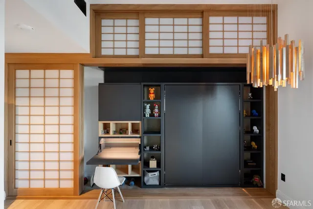 a dining room with furniture a chandelier and window