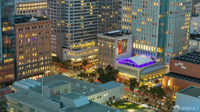 a living room with furniture a flat screen tv and a lamp