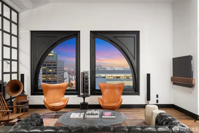 a dining room with furniture and a floor to ceiling window