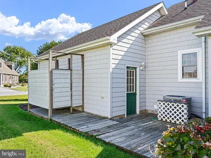 a view of backyard of house with green space