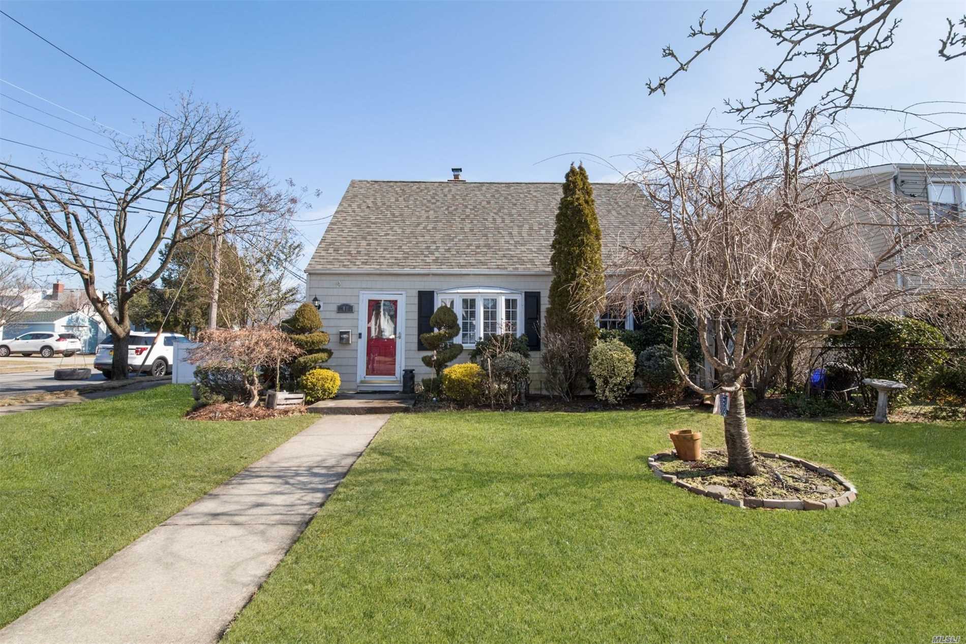 41 Horton Road Valley Stream, NY 11581 - Photo 1 of 1 a front view of a house with garden and trees