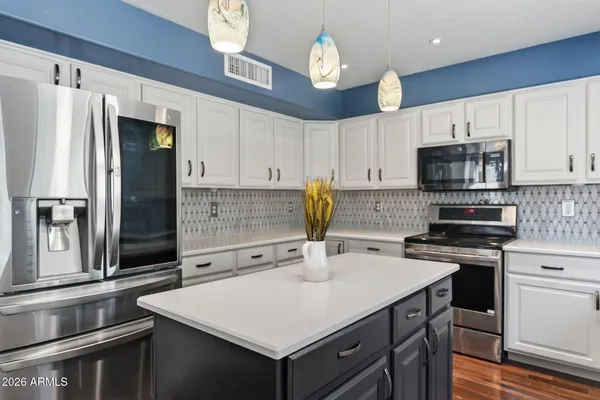 a kitchen with a sink a stove a refrigerator and cabinets