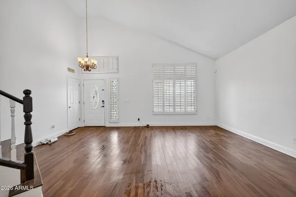 a view of an room with wooden floor and staircase