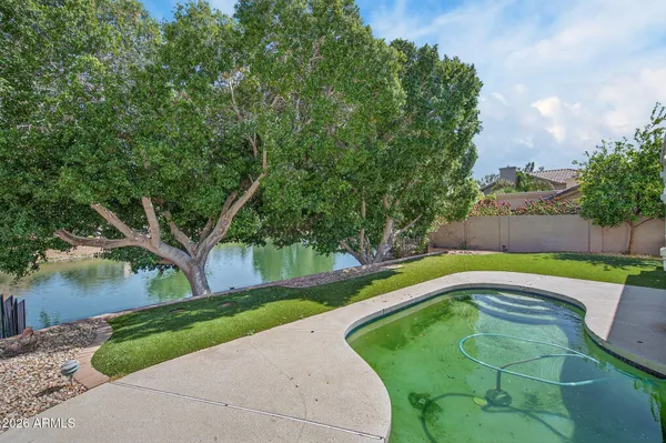 a view of yard with swimming pool and green space