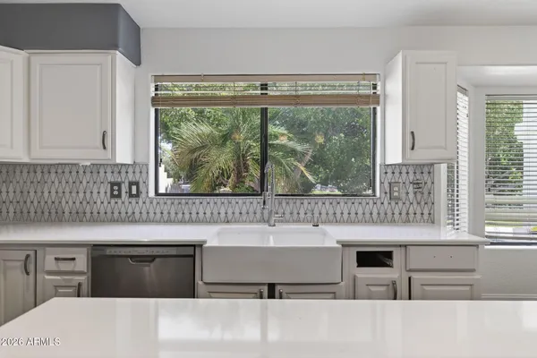 a kitchen with cabinets appliances and a sink
