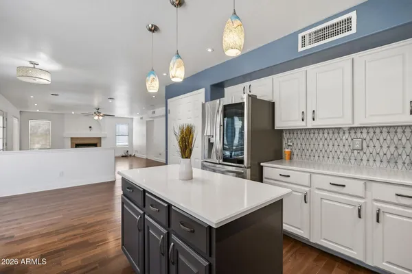 a kitchen with stainless steel appliances wooden floors and wooden cabinets